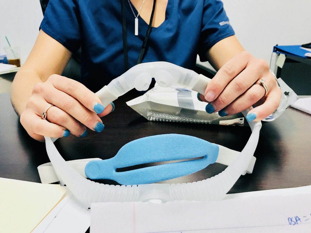 Patient getting fitted for a CPAP sleep mask. Tonythetigersson Tony Andrews Photography.